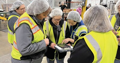 Workers looking on tablet. 